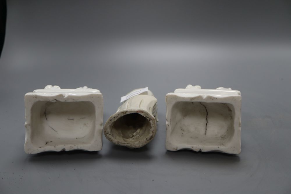 A pair of Chinese blanc de chine lion-dogs and a similar group of Guanyin, height 17cm